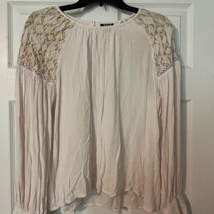 Ivory colored long sleeved with detailed shoulders.